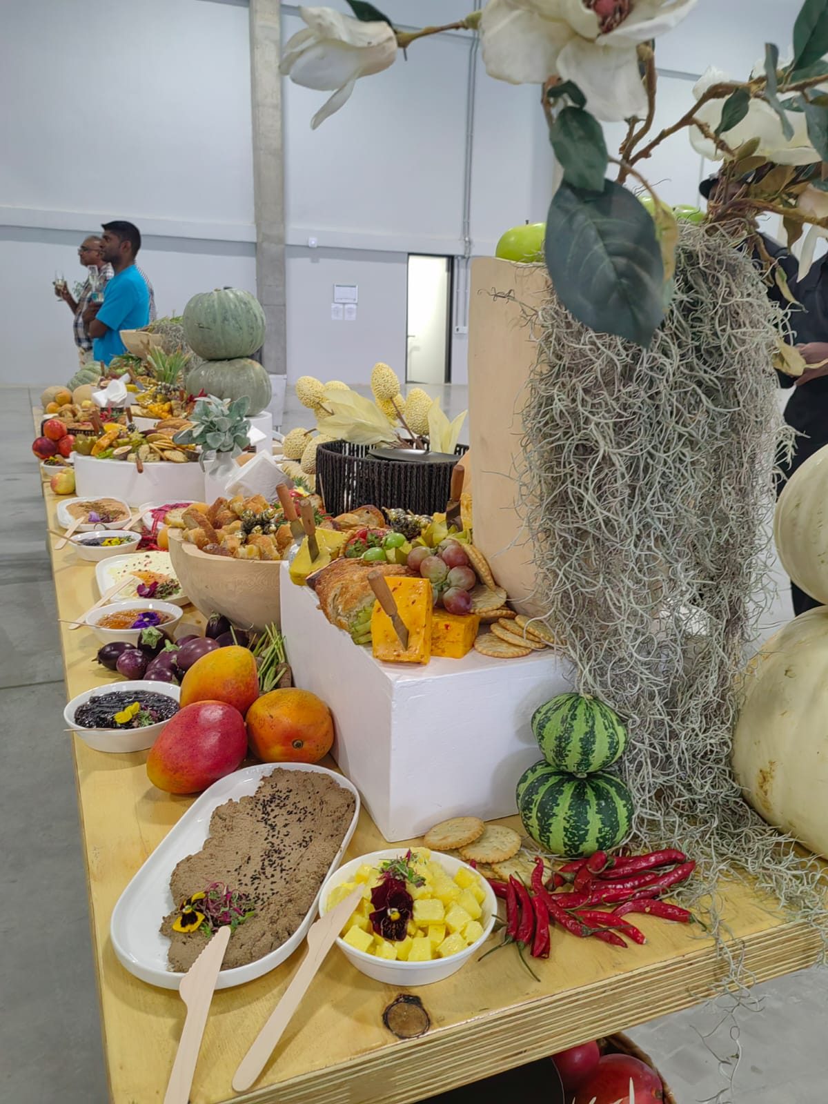 The long harvest table, styled with greenery