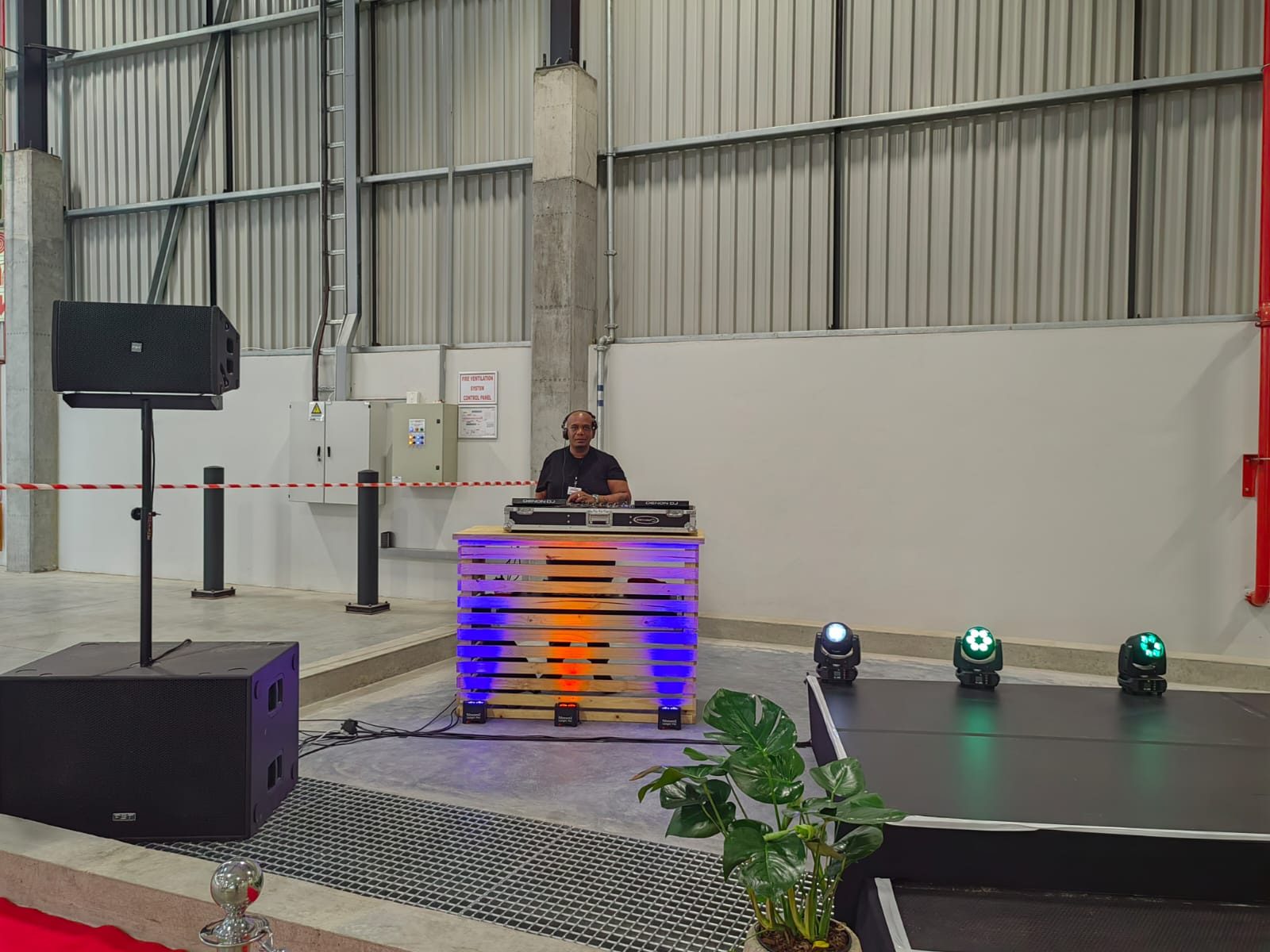 Uplit DJ booth with moving heads on the stage edge