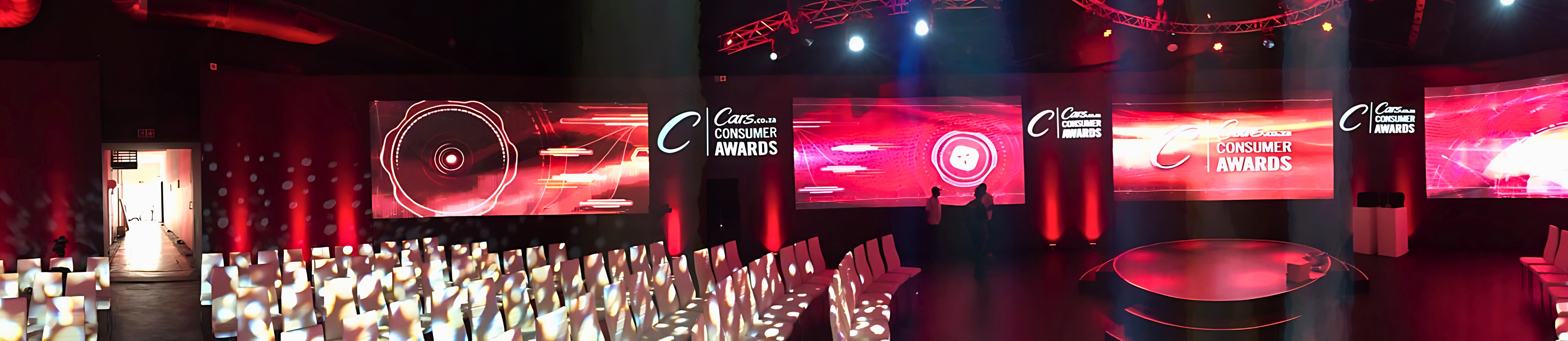 Cars.co.za Consumers Awards hall with LED branding, circular stage, and curved rows of white seating
