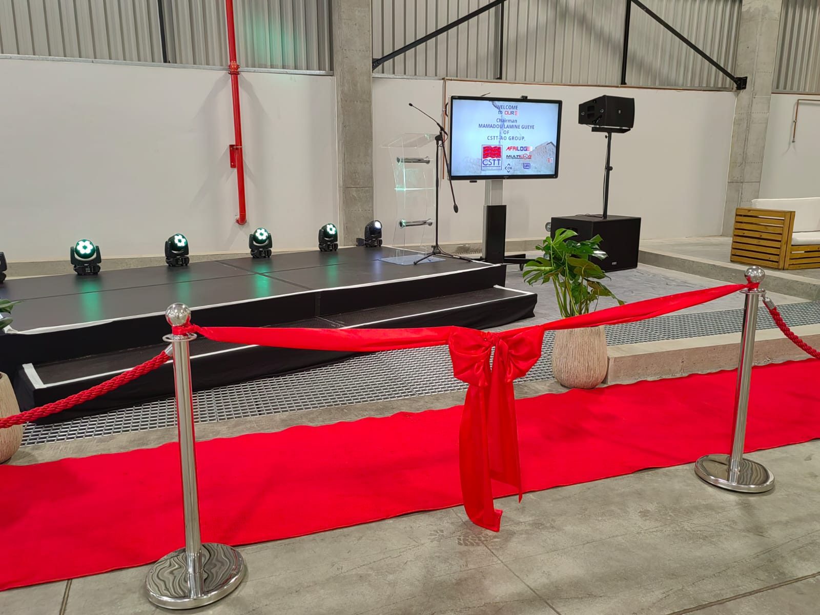 Red-carpet ribbon line in front of the stage