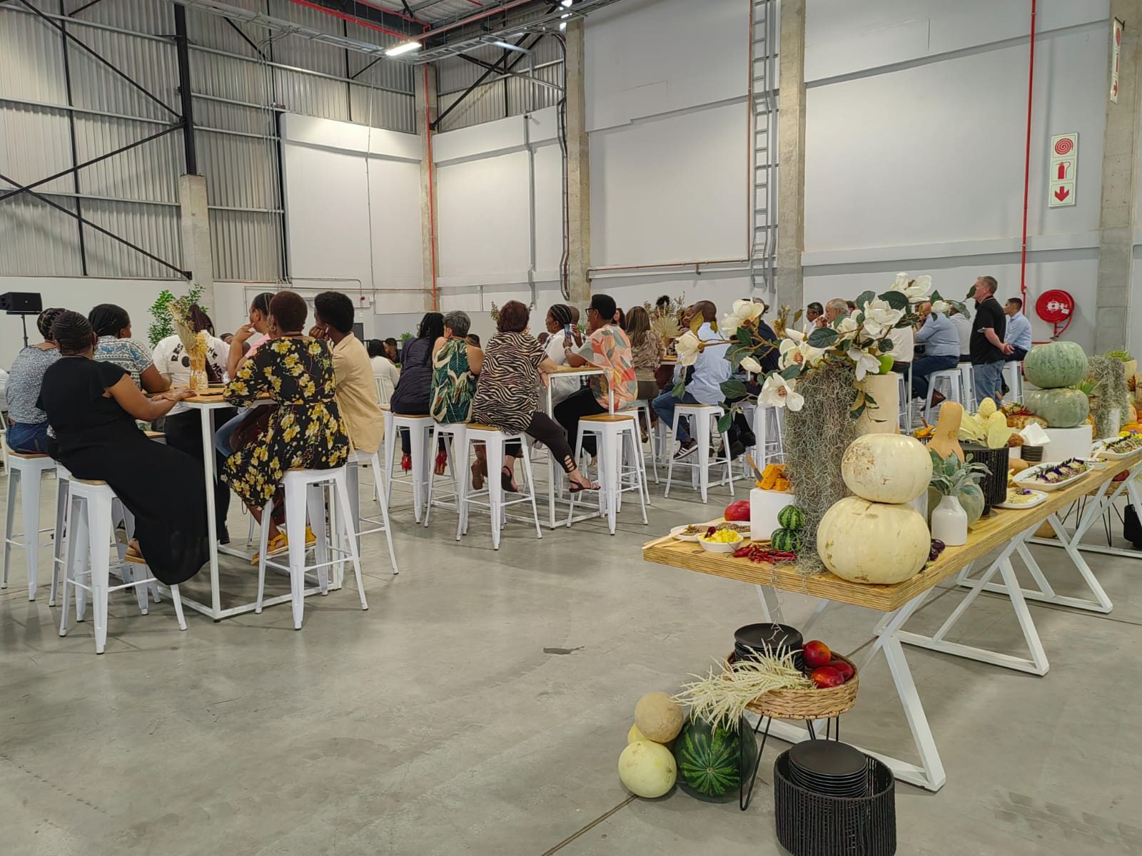 Guests at bar tables beside the harvest-table styling